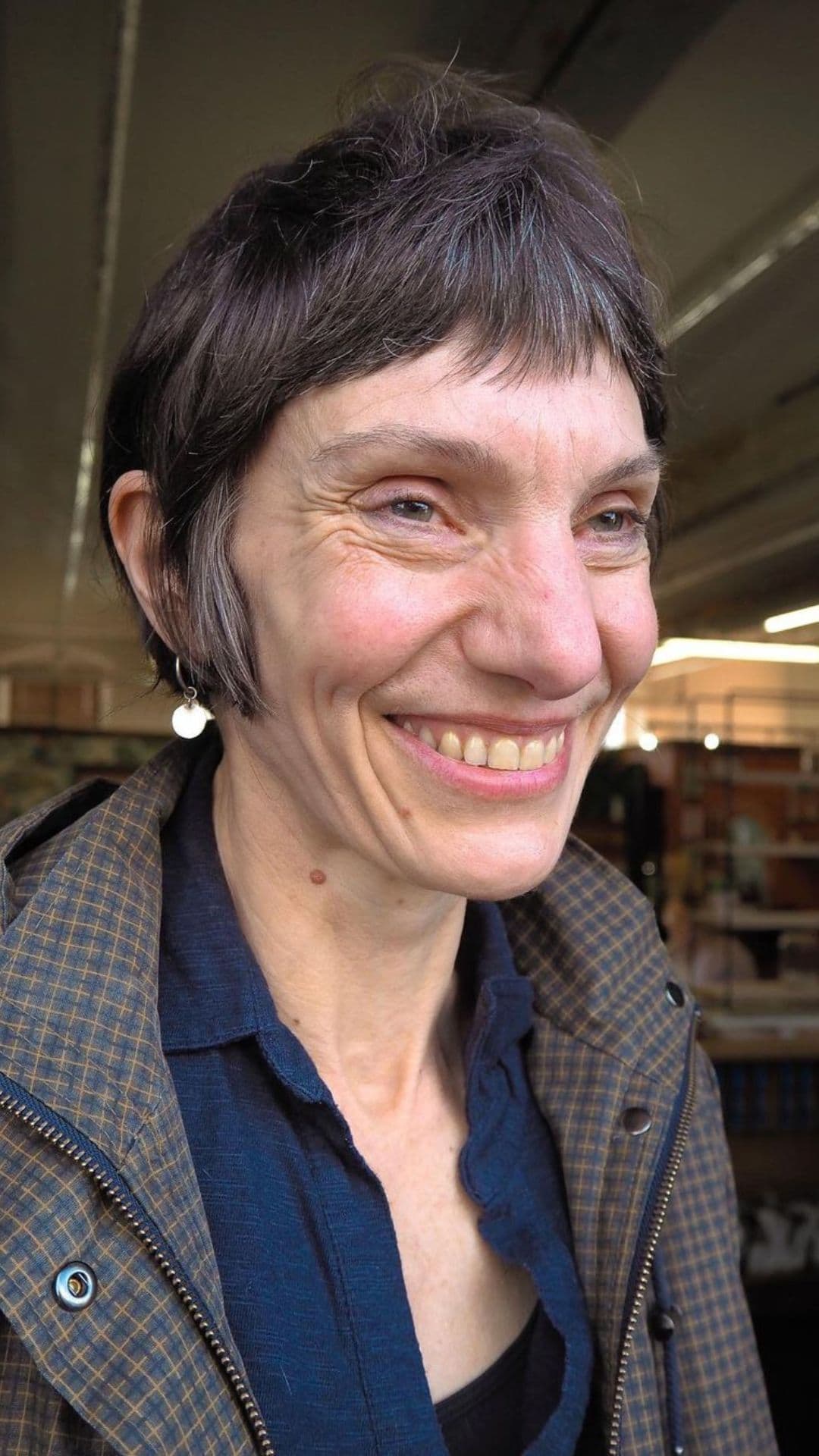 An older woman modelling a shaggy pixie bob hairstyle.
