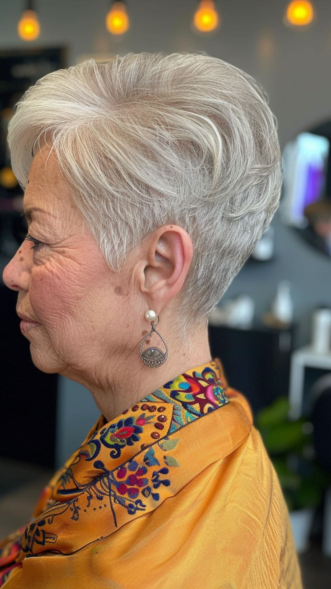 An older woman modelling a short tapered cut.