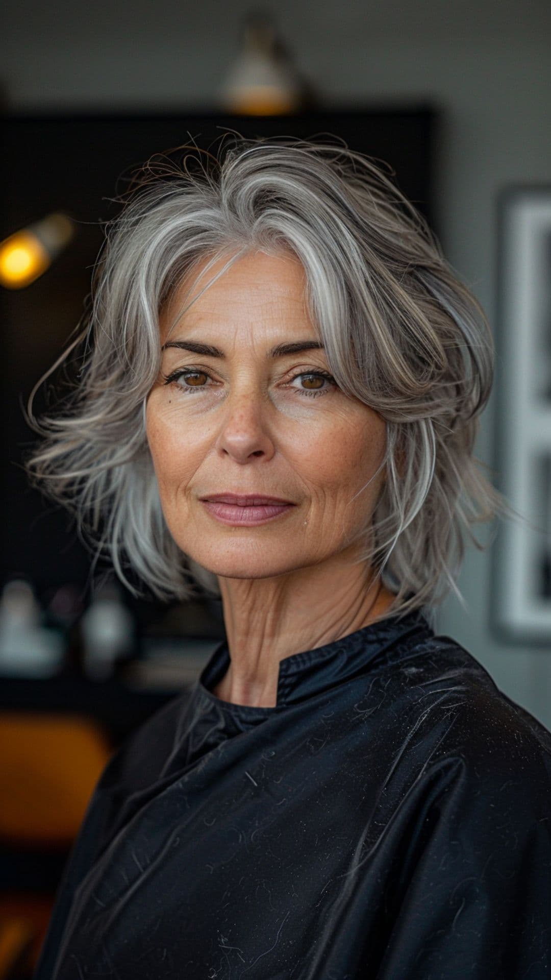 An old woman modelling a silver highlights on dark hair.