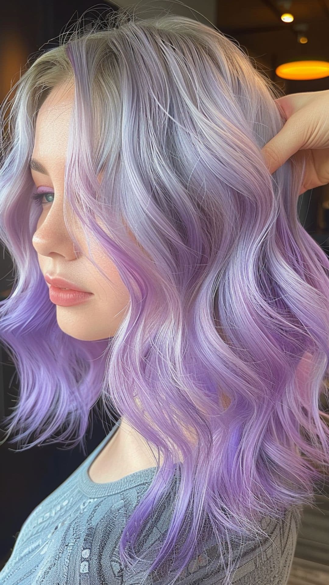 A woman modelling a silver to lilac ombre hair.