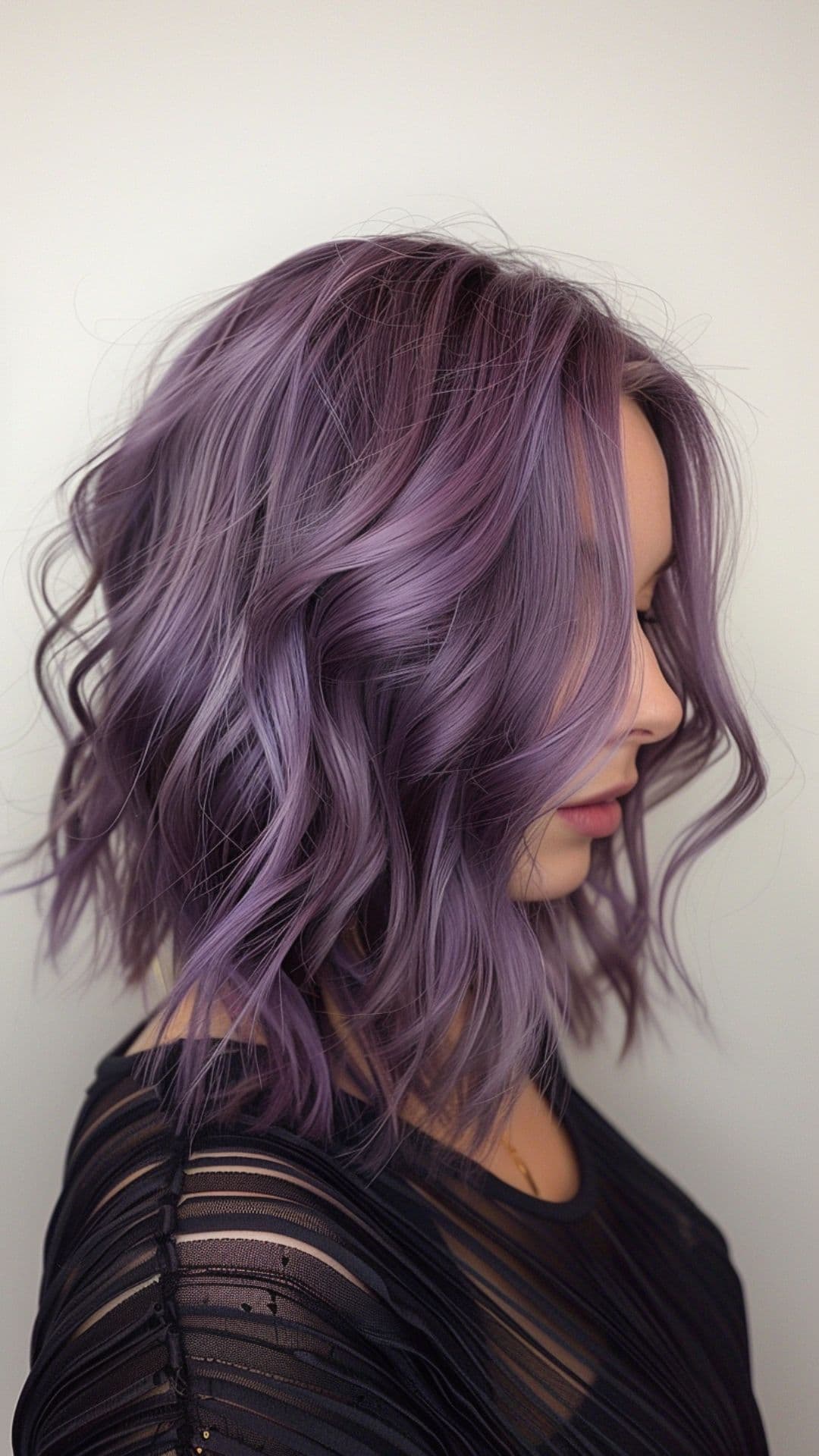 A woman modelling a smokey purple hair color.