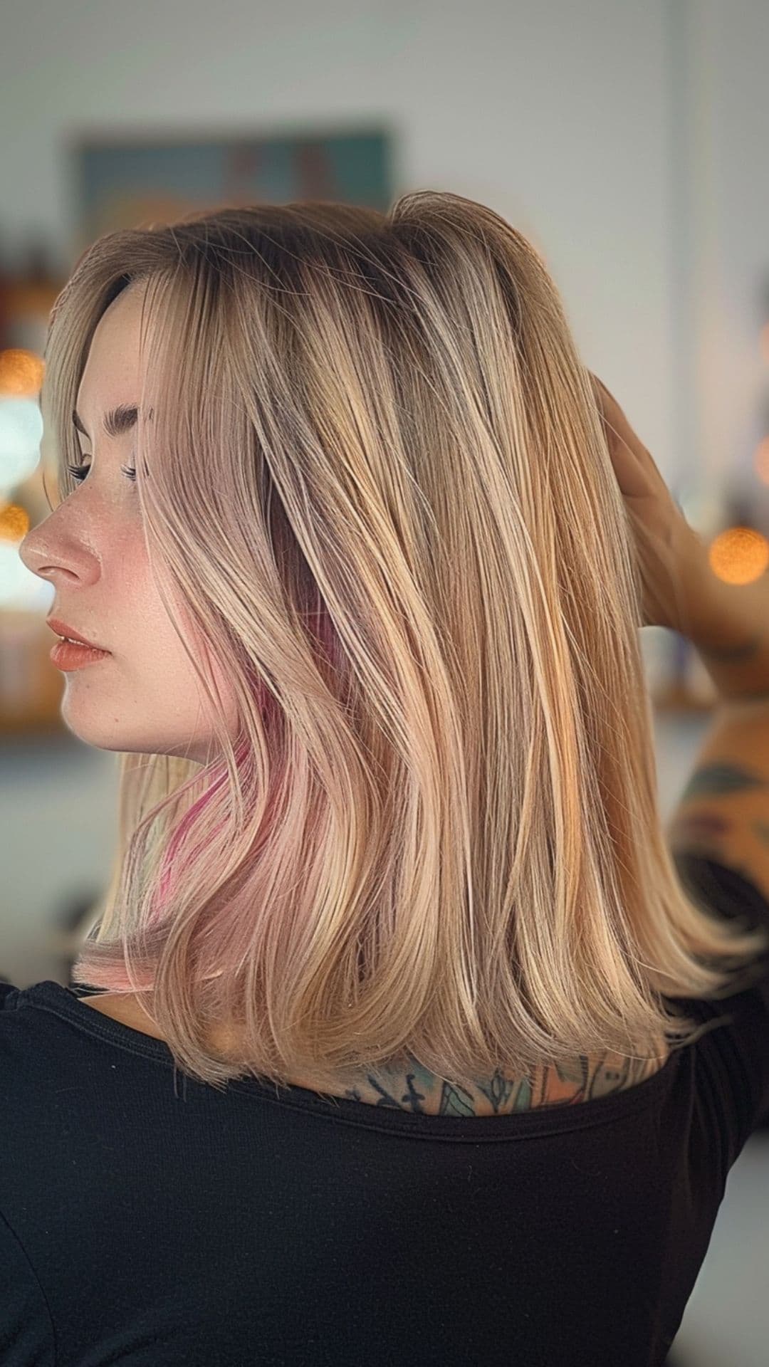 A woman modelling a subtle pink streaks hair.