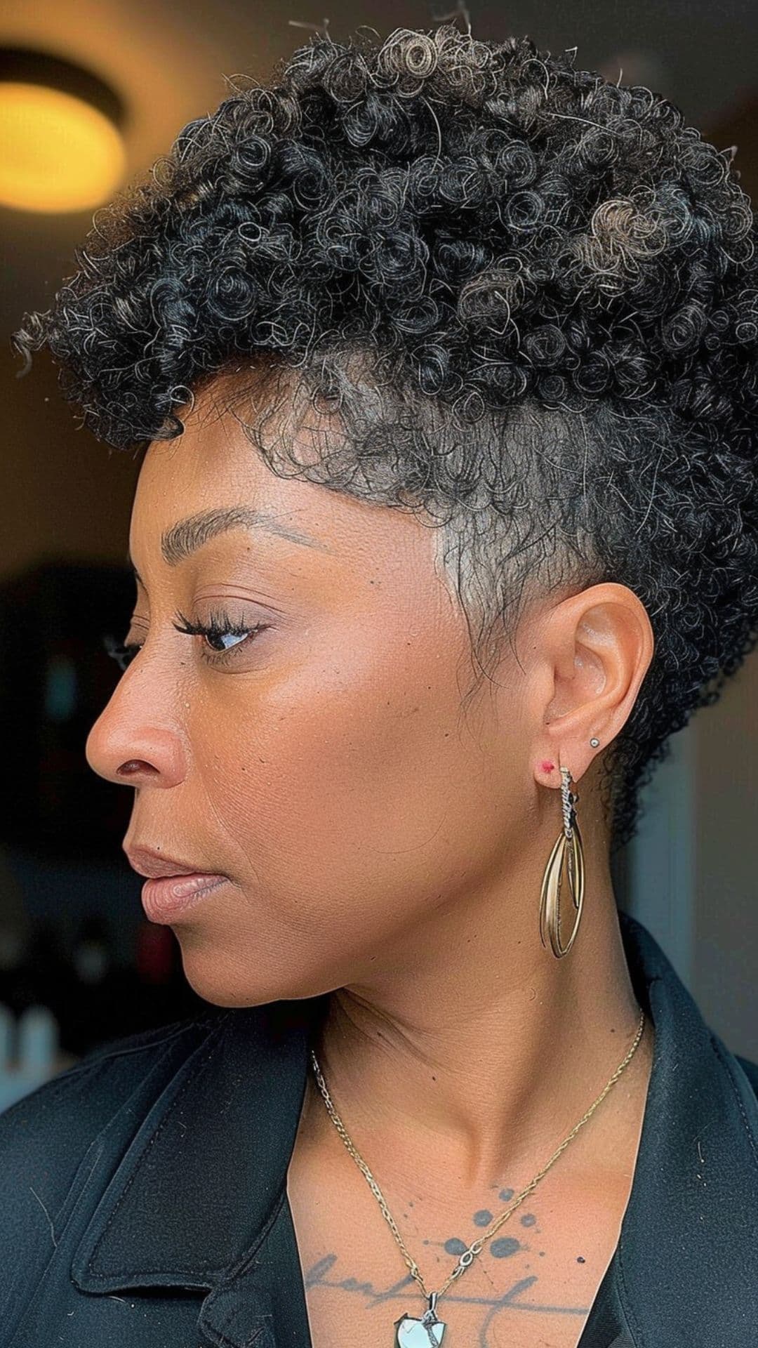 An older black woman modelling a tapered natural cut.