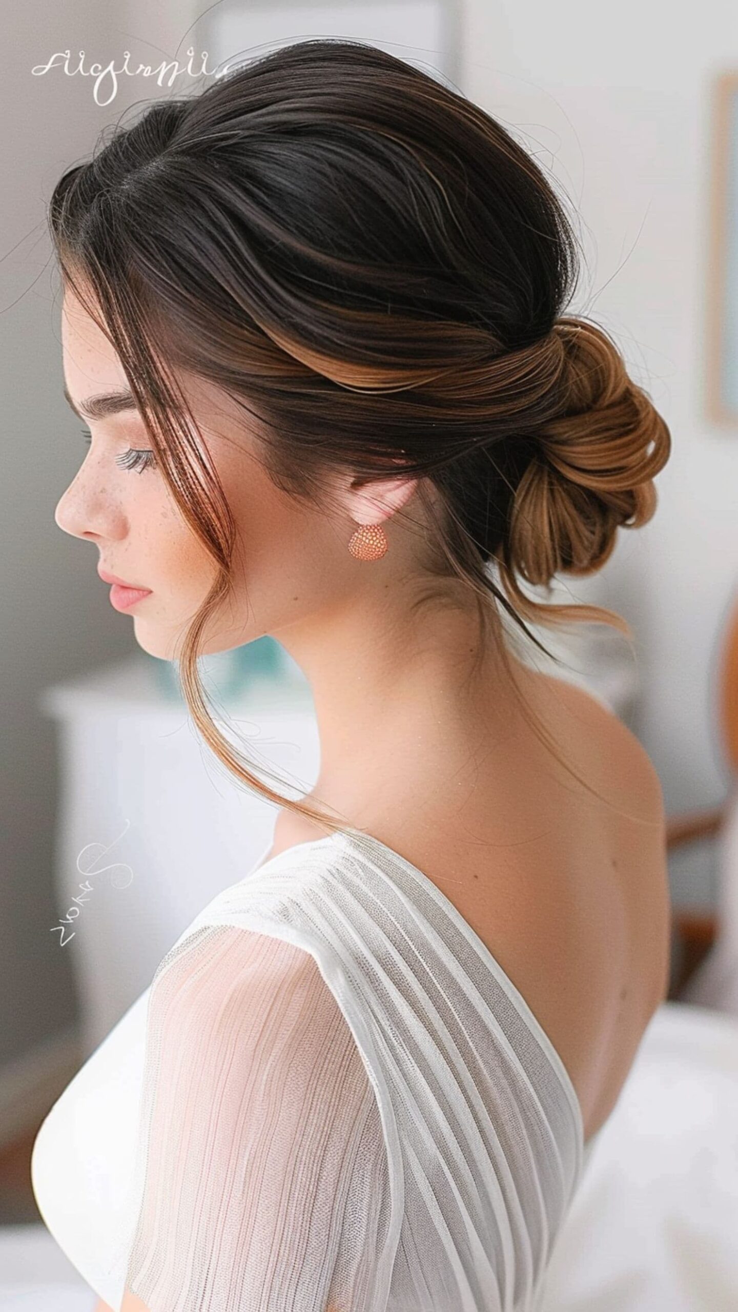 A woman modelling a textured low chignon hairstyle.