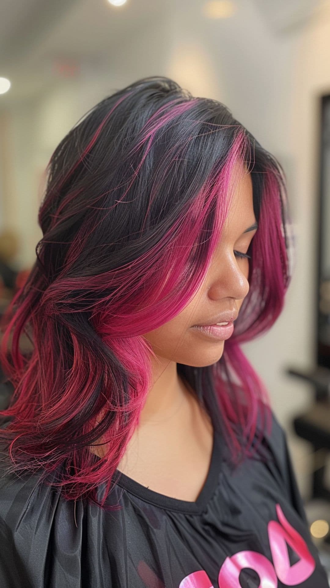 A woman modelling a black and magenta hair.