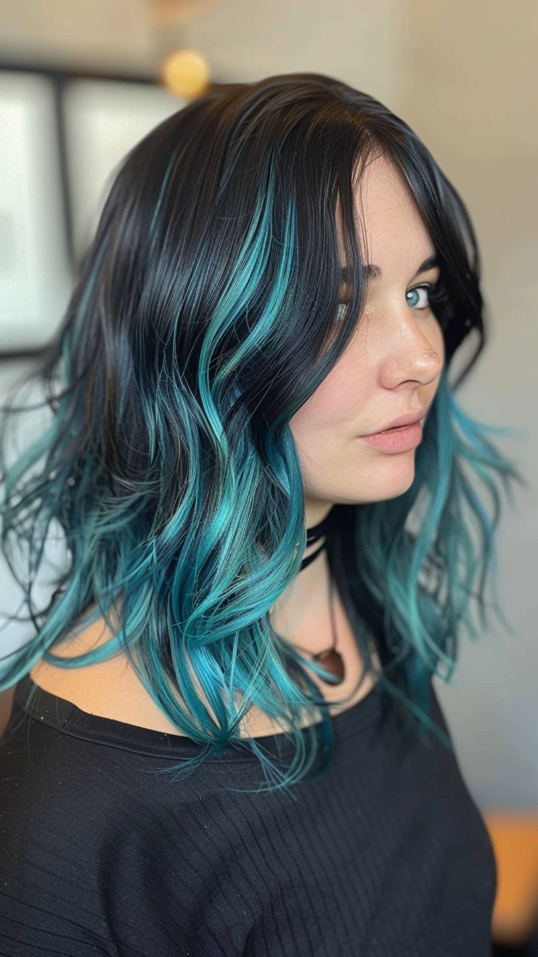 A woman modelling a black and teal hair.