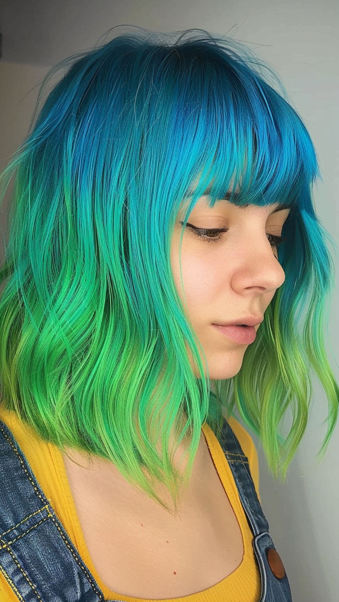 A woman modelling a blue and green hair.