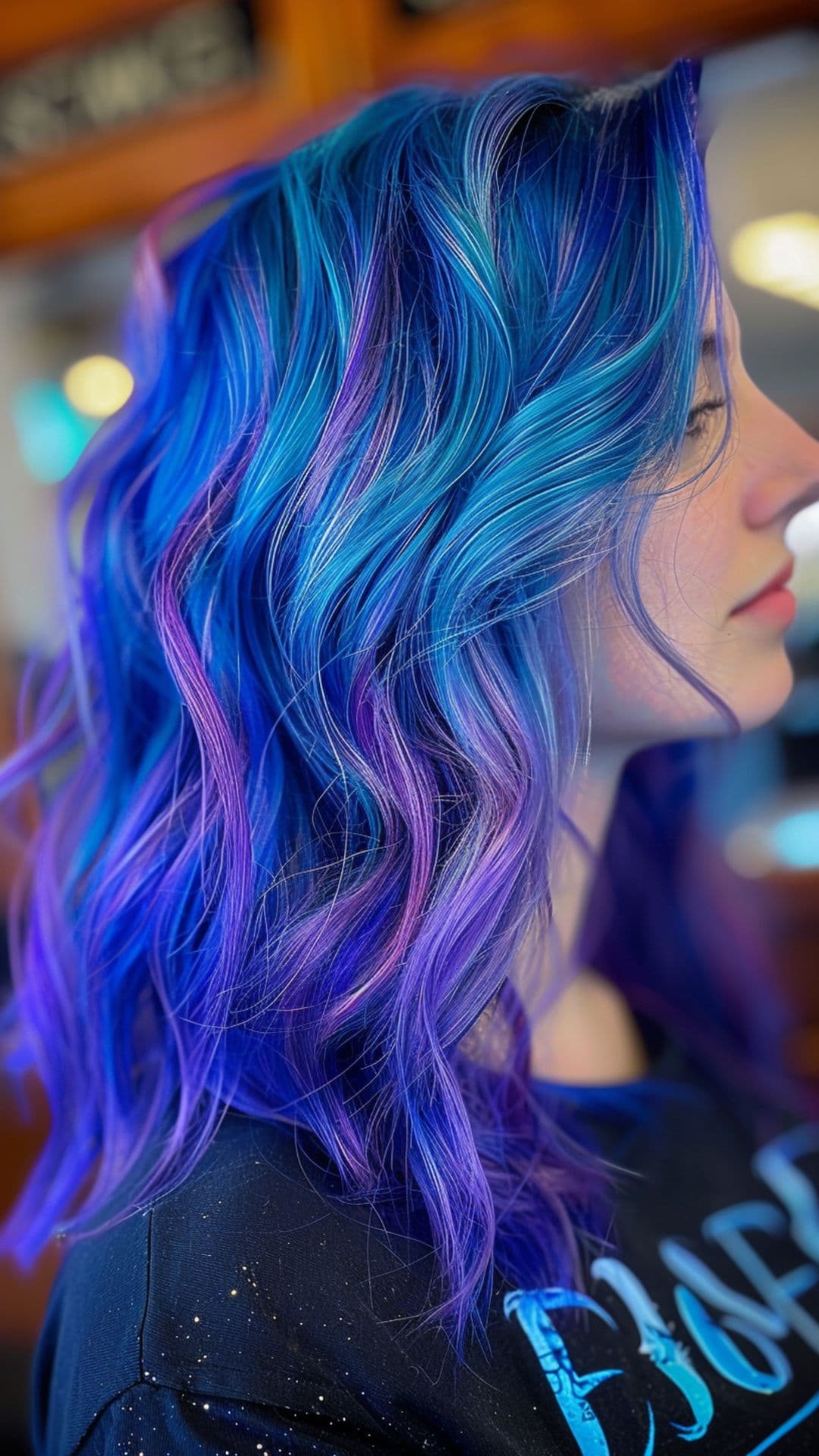 A woman modelling a blue and purple hair.
