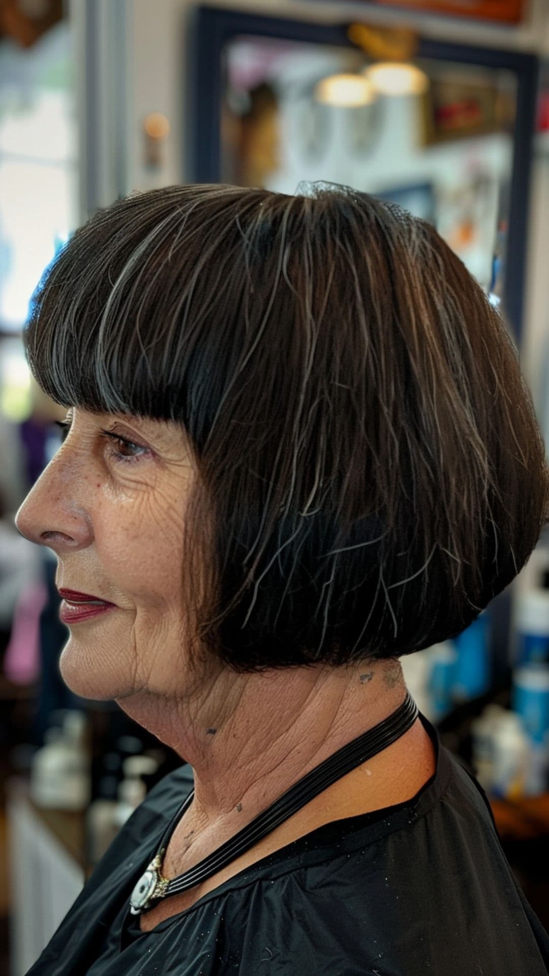 An old woman modelling a blunt bangs.