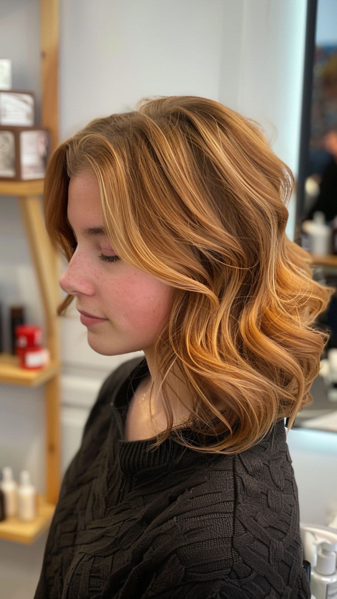 A woman modelling a caramel swirls on light brown hair.