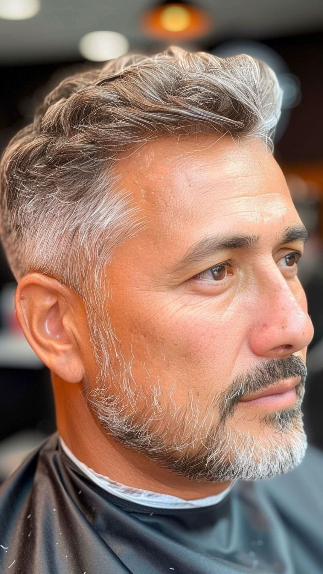 A middle aged man modelling a clipper haircut.
