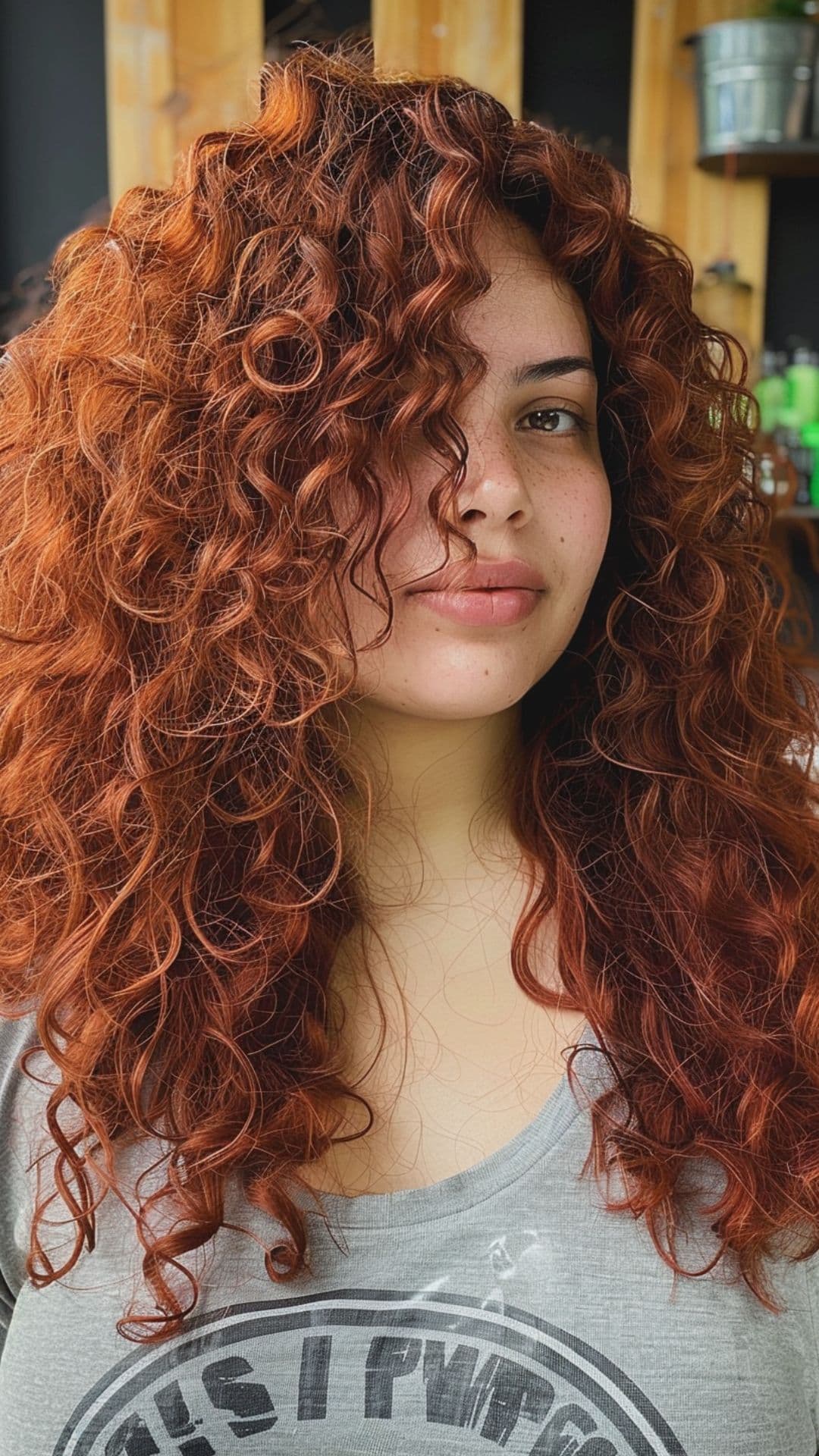 A woman modelling a copper red curly hair.