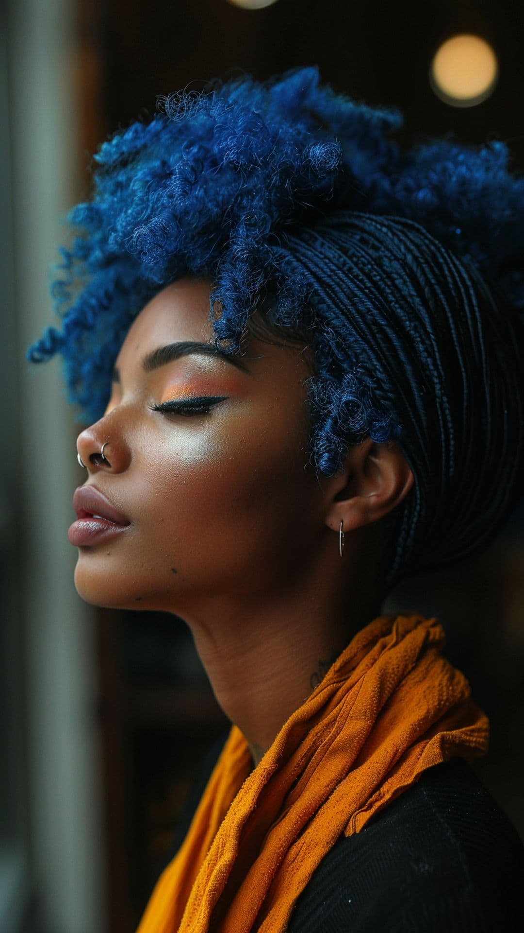 A black woman modelling a deep blue curly hair.