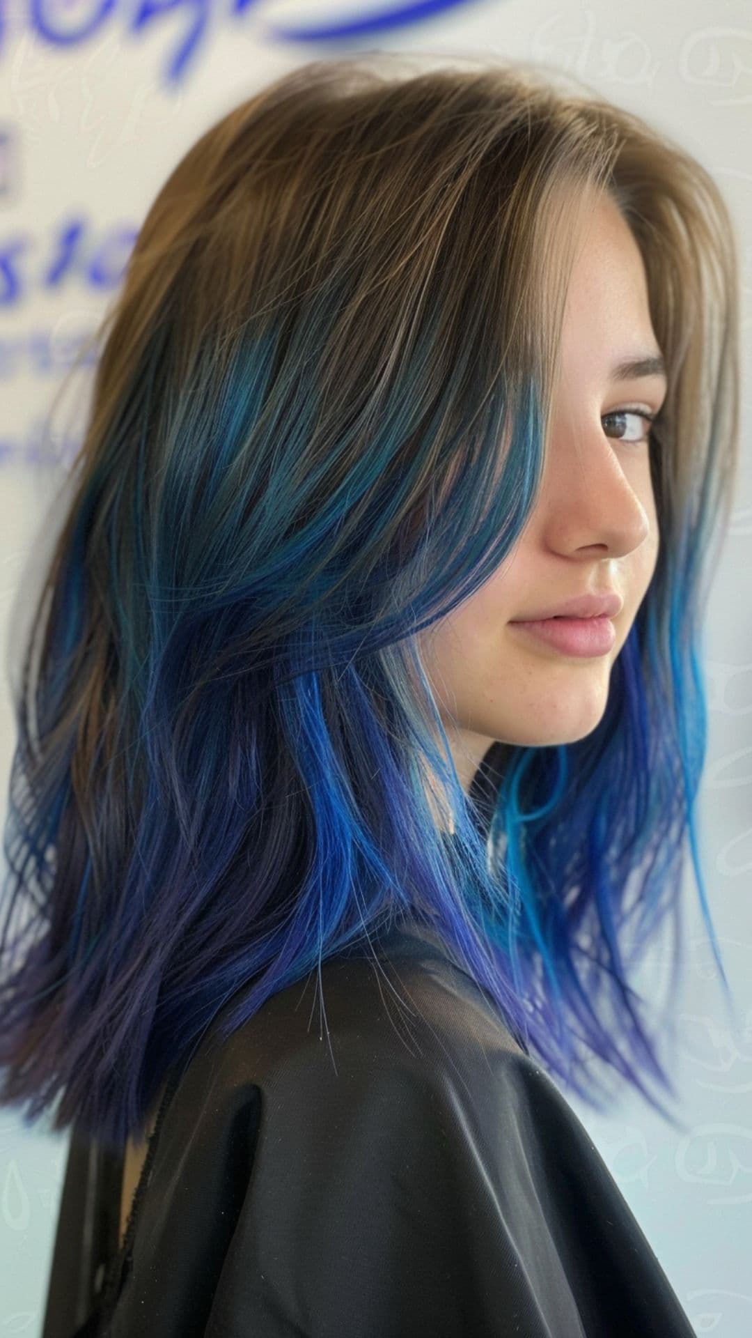 A teen girl modelling an electric blue hair.
