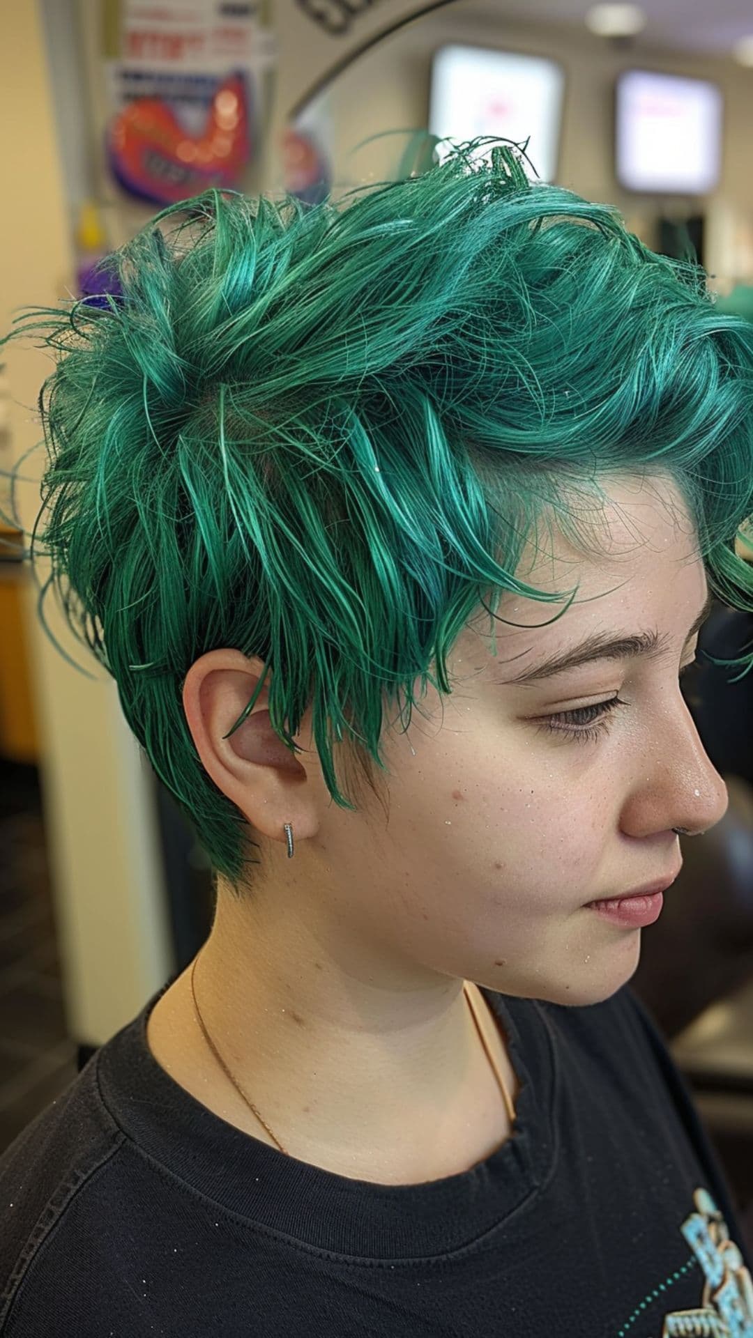 A woman modelling a short emerald green hair.