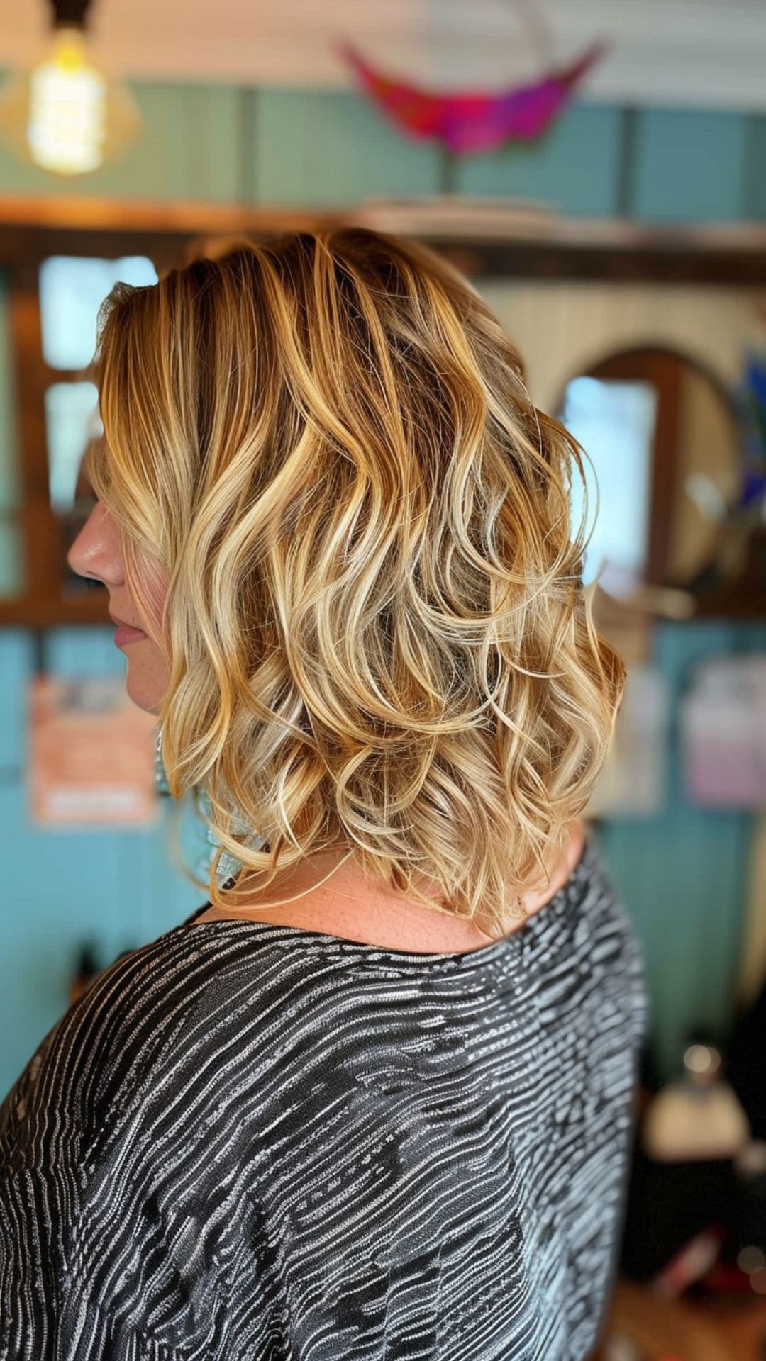 A woman modelling a honey blonde highlights hair.