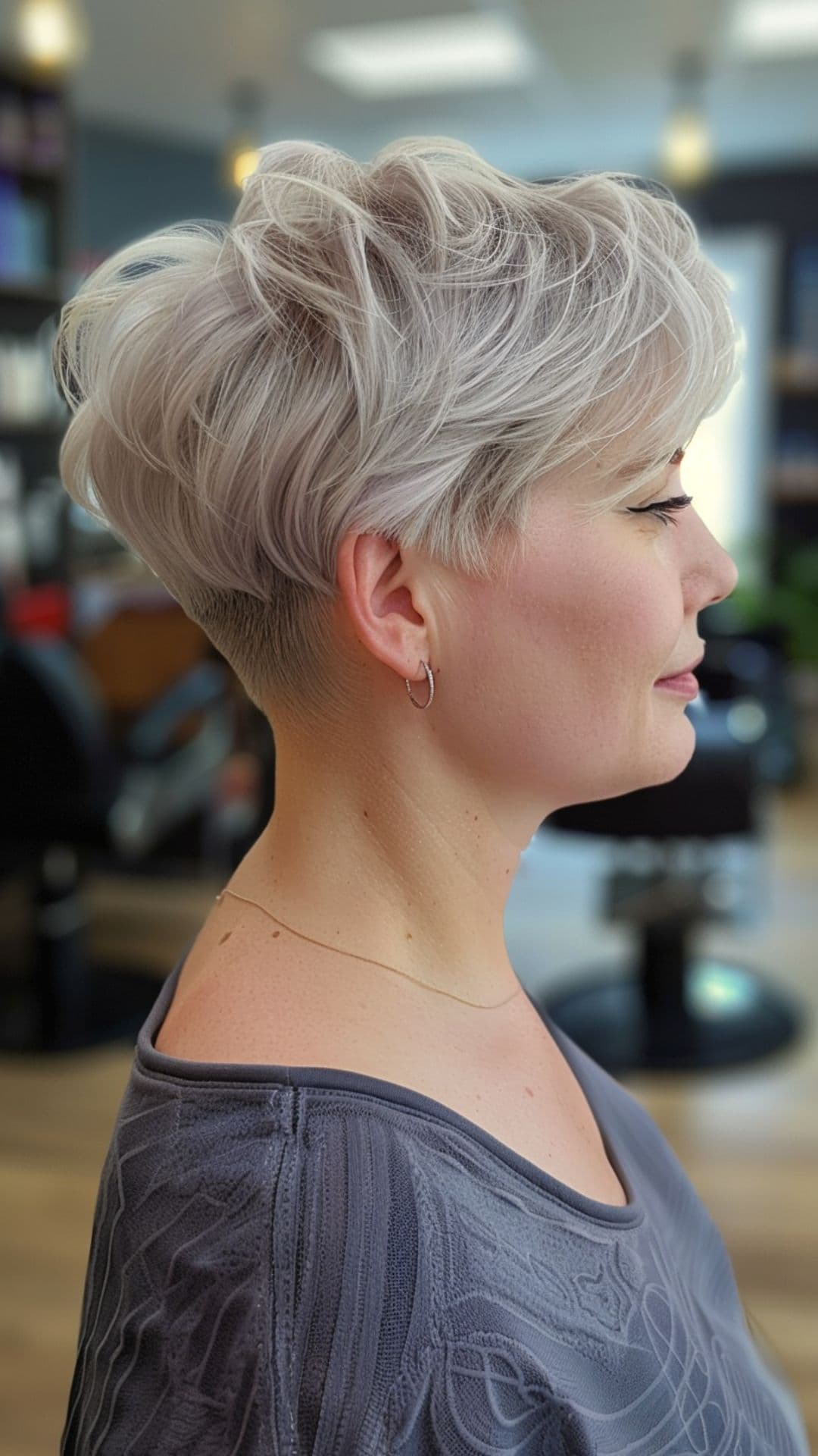 A woman modelling a short icy silver hair.