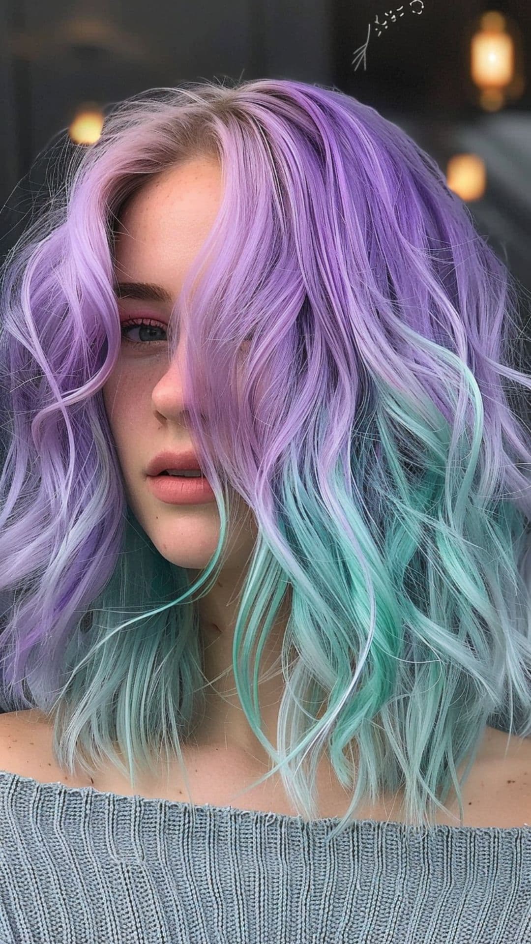 A woman modelling a lavender and aquamarine hair.