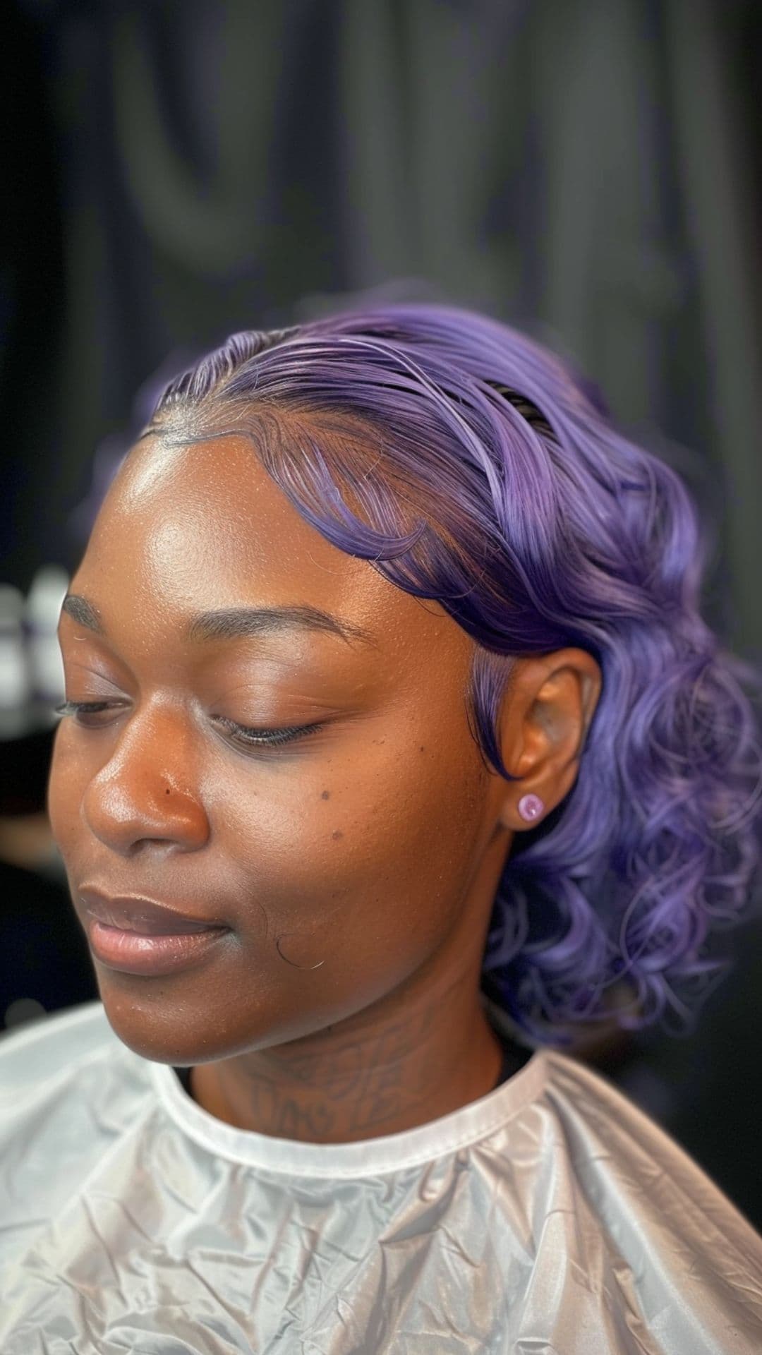 A black woman modelling a lavender hair.