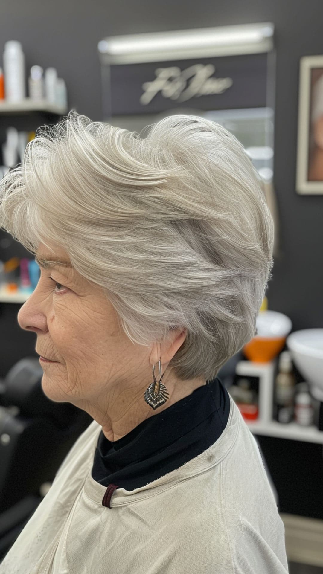 An old woman modelling a feathered haircut.