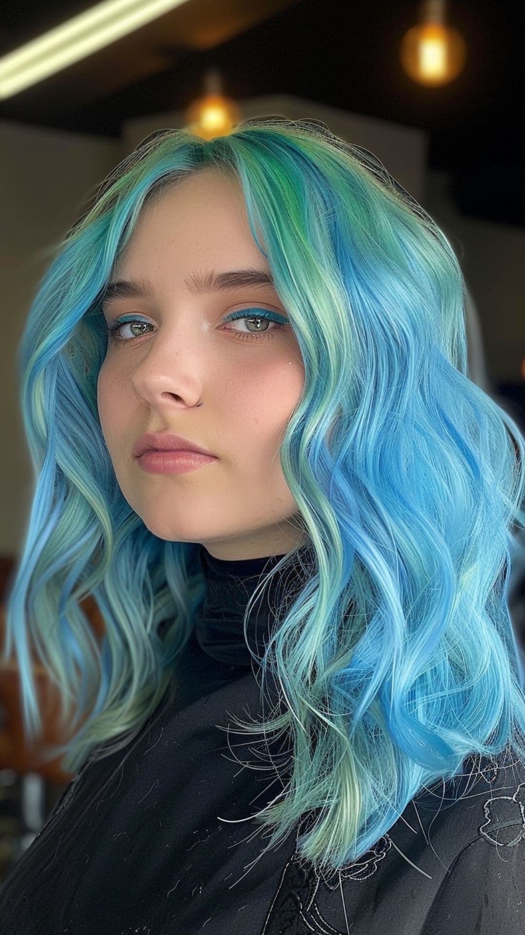 A woman modelling a pastel blue and mint green hair.