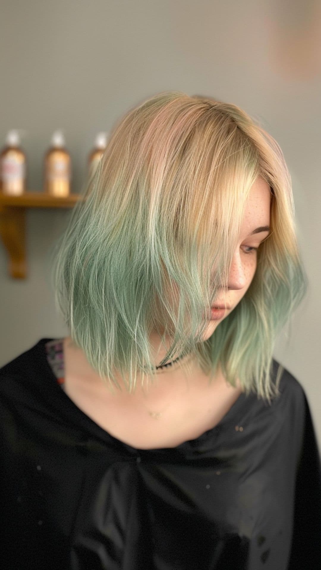 A woman modelling a pastel green hair ombre.