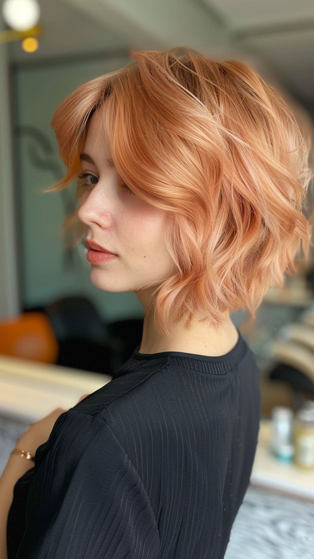 A woman modelling a short peach hair.