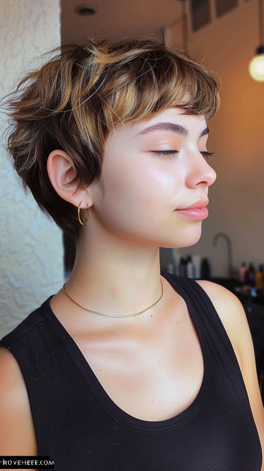 A woman modelling a retro-inspired pixie cut.