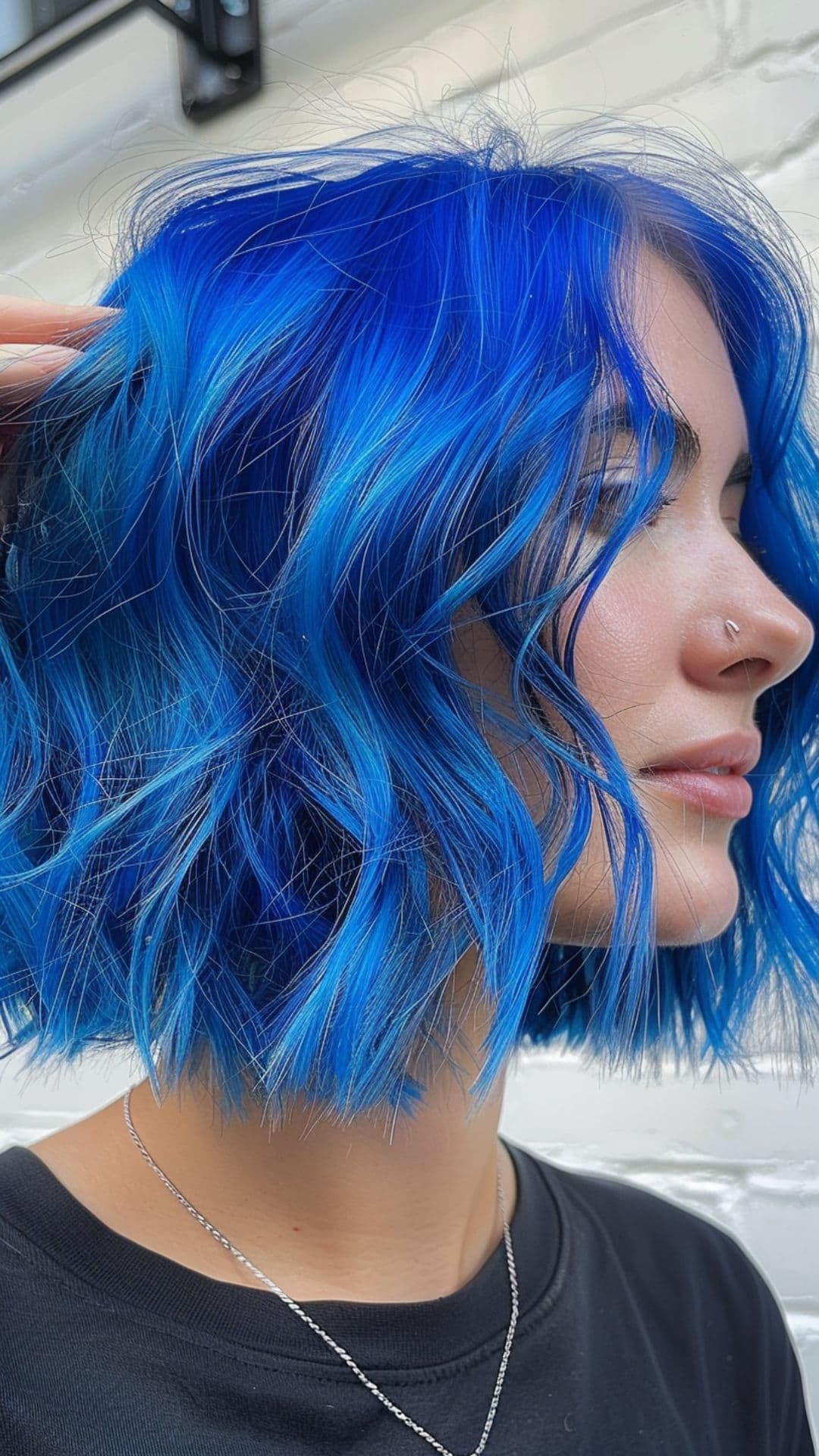 A woman modelling a short sapphire blue hair.