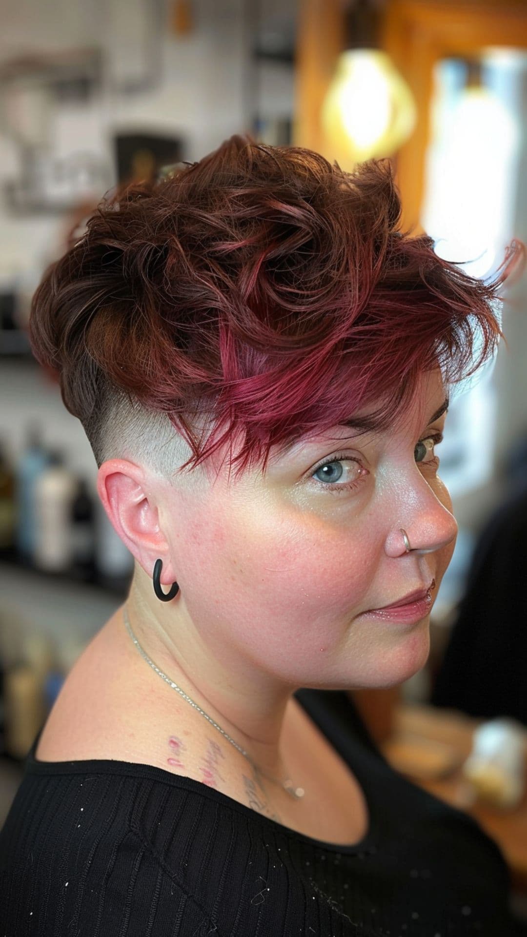 A woman modelling a side-swept pixie with undercut.