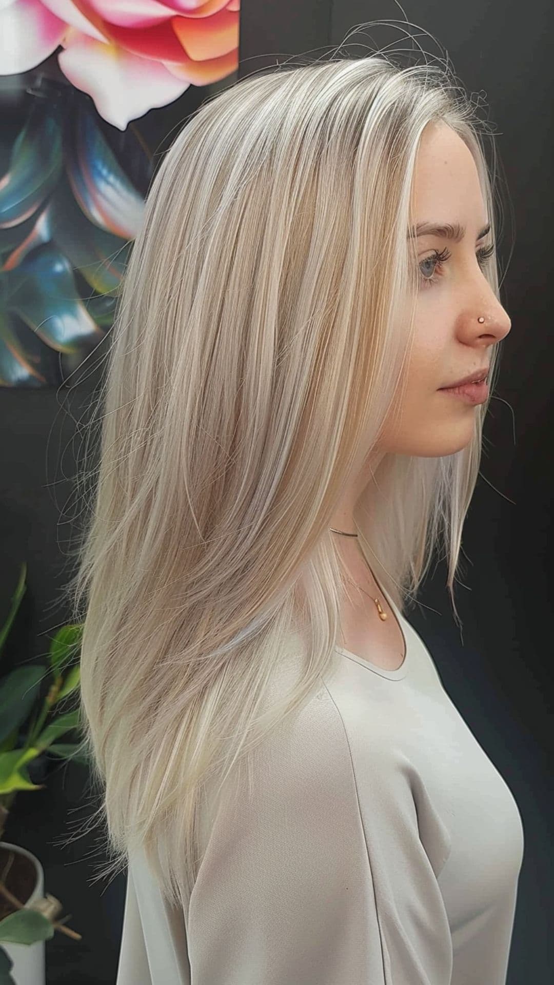 A woman modelling a soft platinum highlights hair.