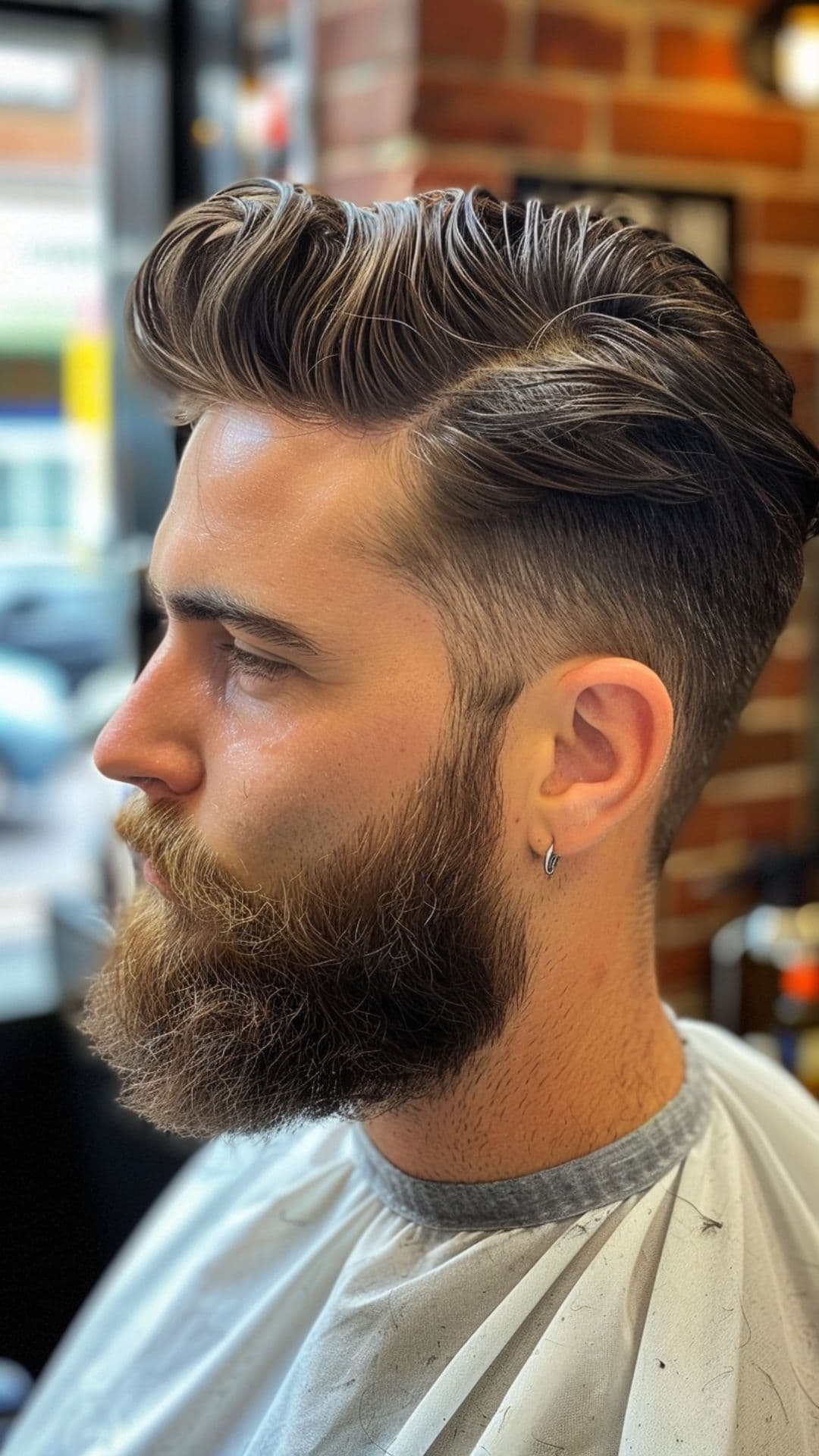 A man modelling a taper fade haircut with beard.
