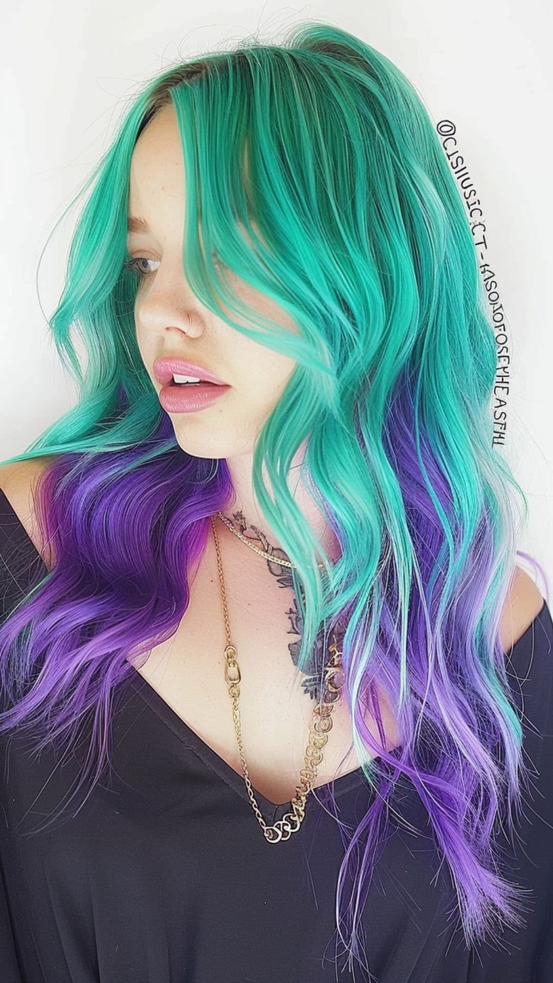 A woman modelling a teal and purple hair.