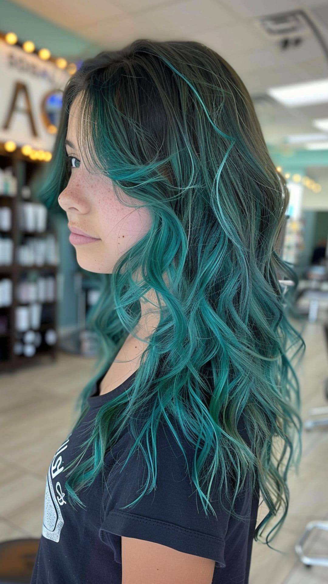 A young woman modelling a teal hair.