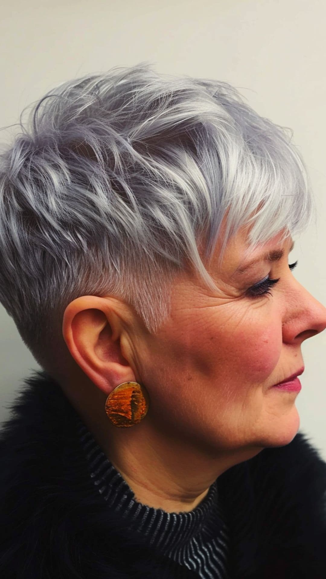 An old woman modelling a textured pixie with undercut.