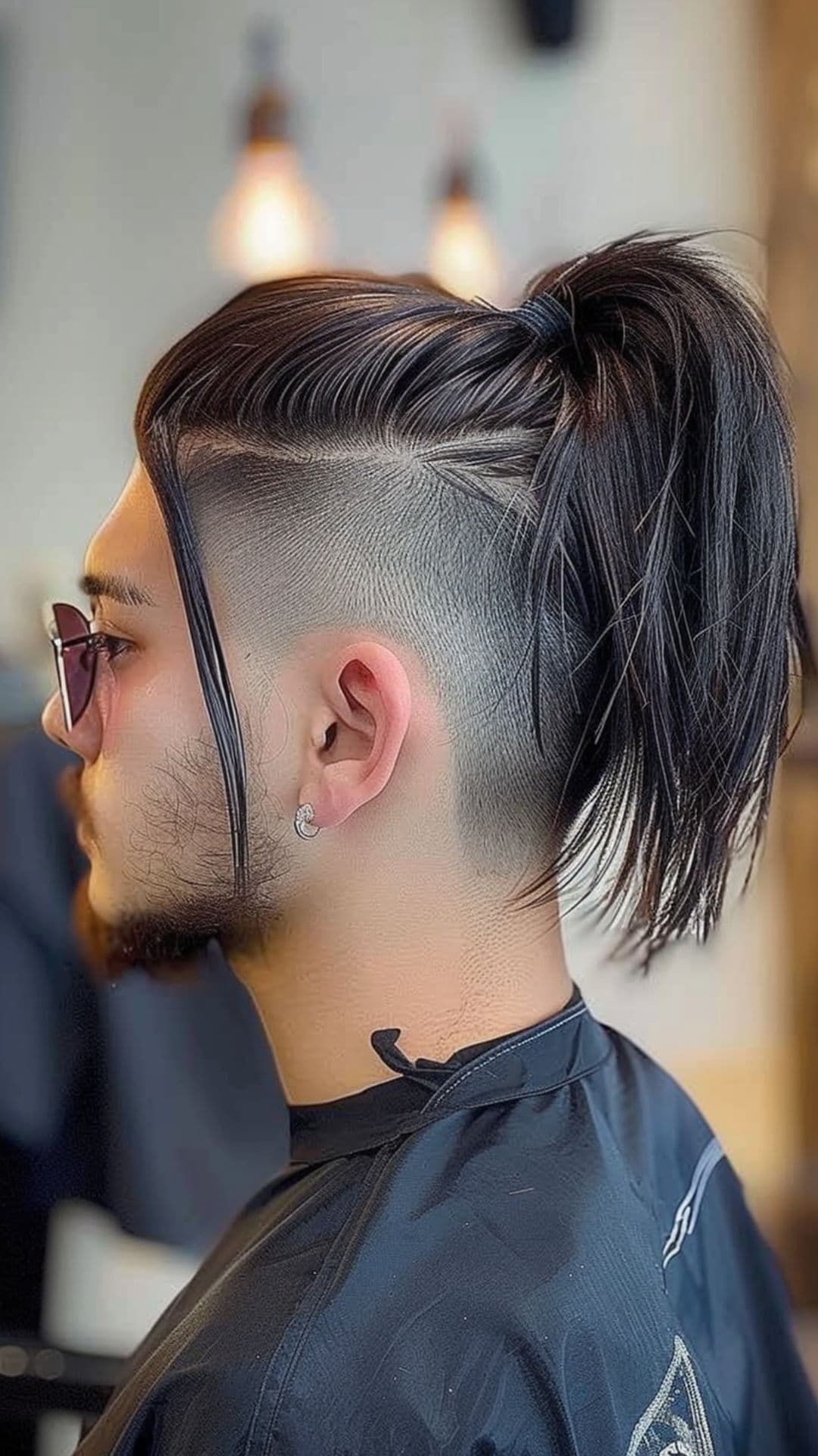 A man modelling an undercut with ponytail.