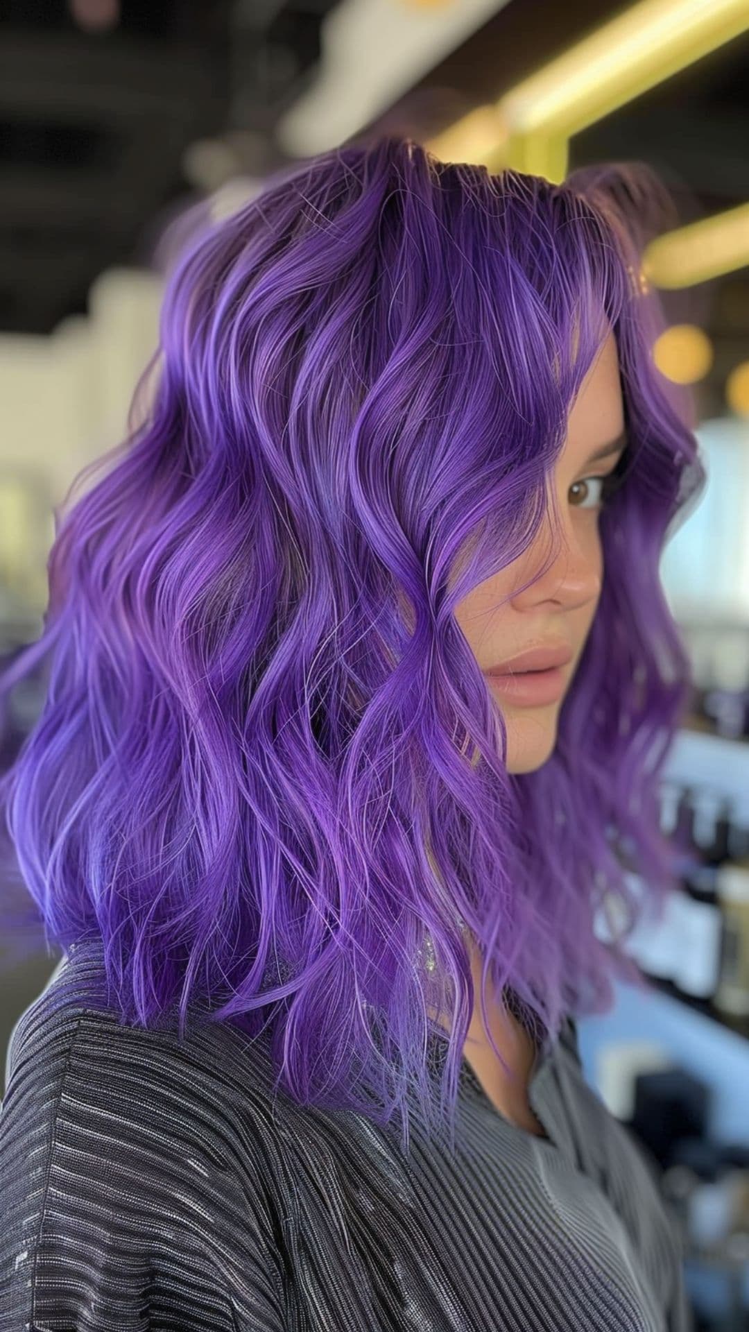 A woman modelling a vibrant purple hair.