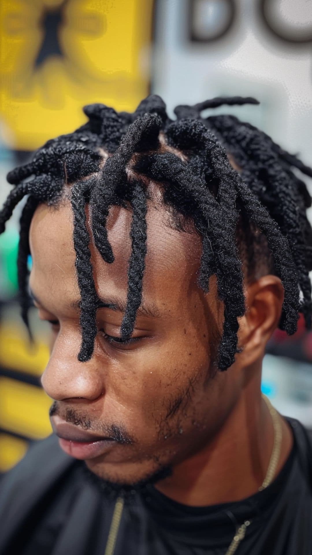 A man modelling a short dreads hairstyle.