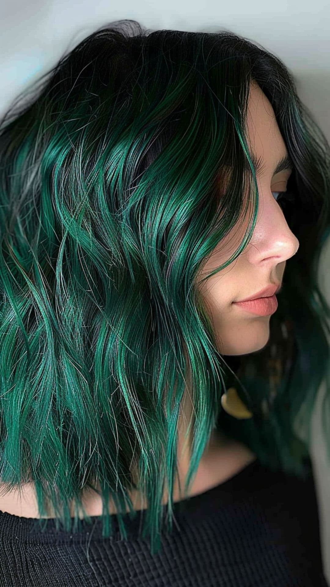 A woman a rich, dark green hair.