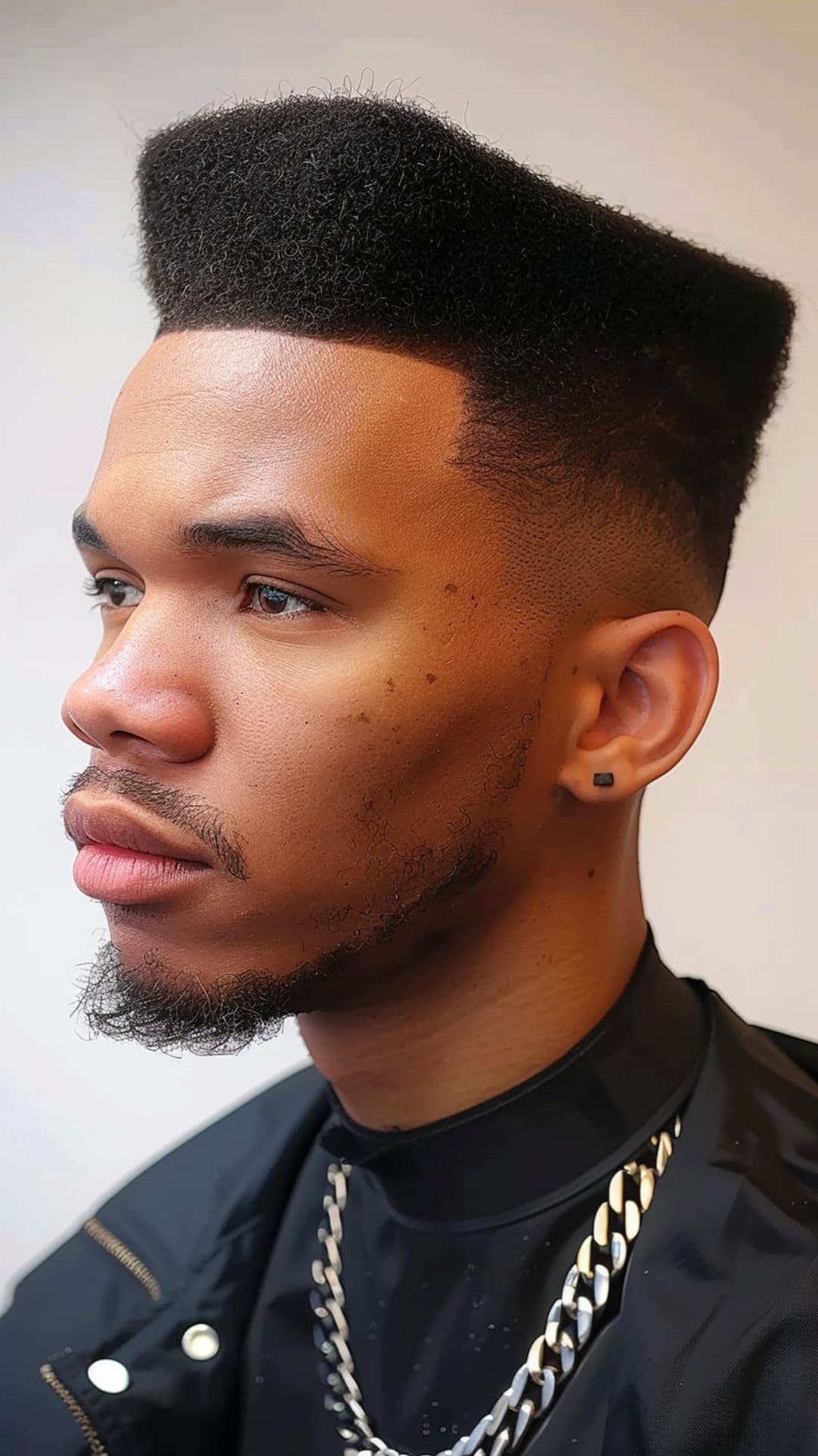A black man modelling a flat top hairstyle.
