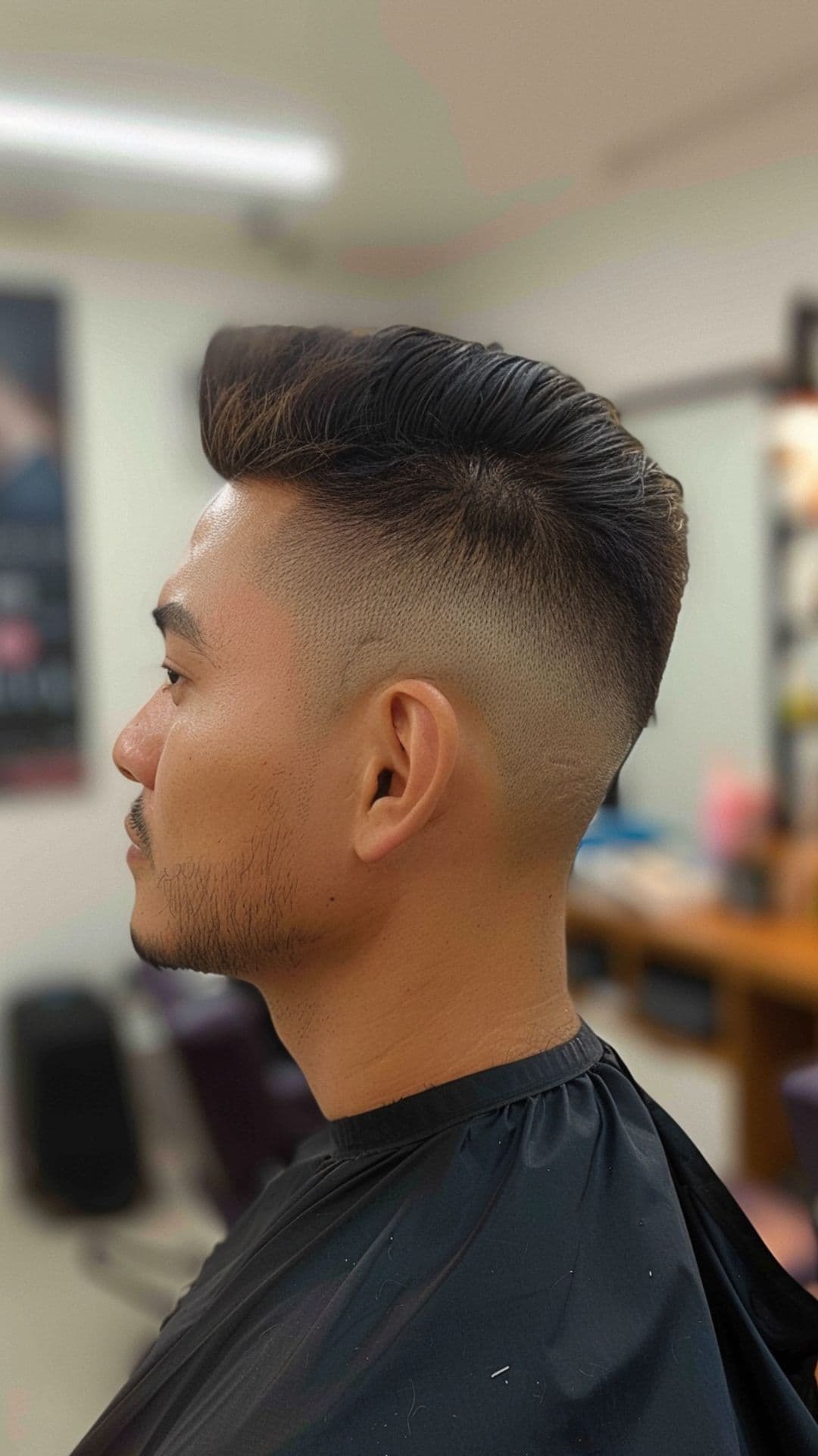 A man modelling a high fade haircut.