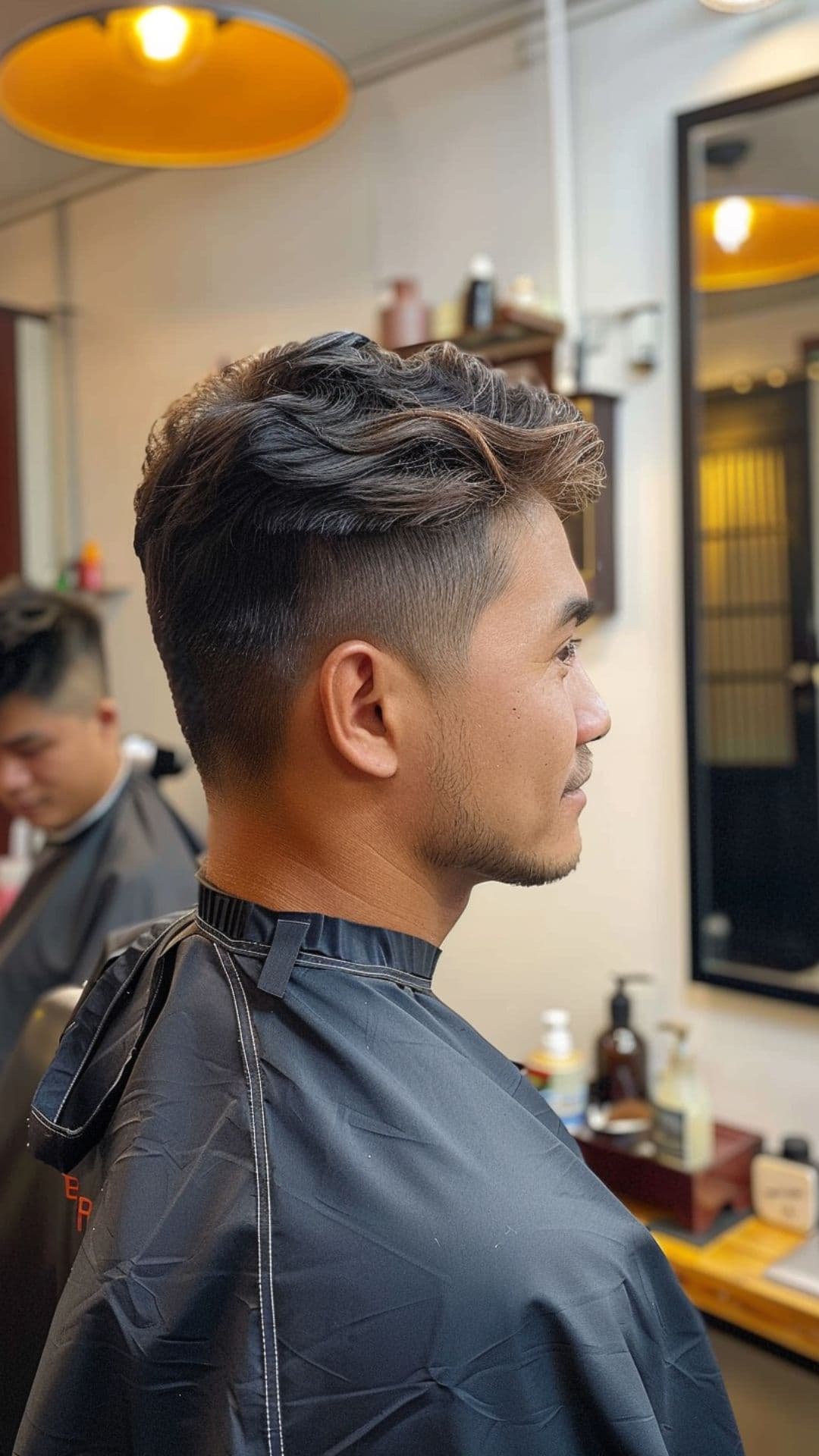 A man modelling a taper fade haircut.