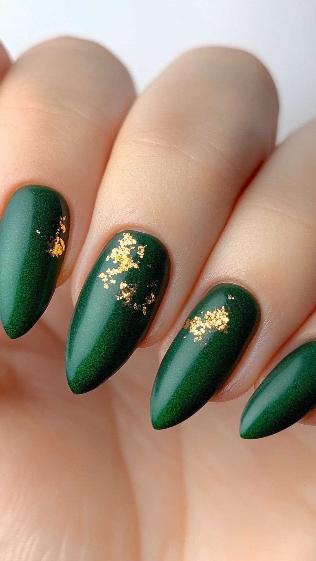 Woman's nails in Forest Green with Gold Flakes.