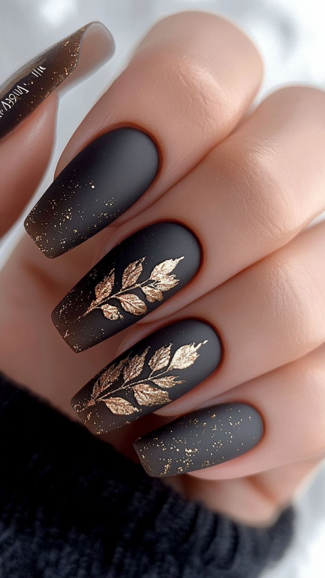 Woman's nails in Matte Brown with Gold Leaf Accents.