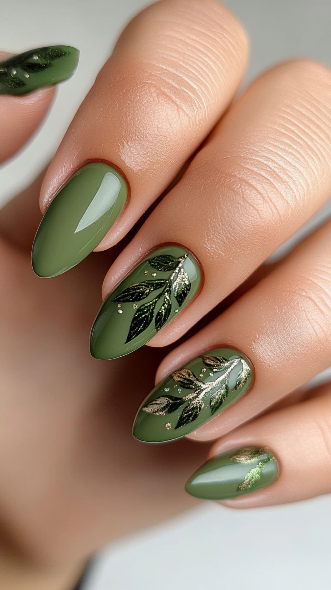 Woman's nails with Olive Green with Leaf Details design.