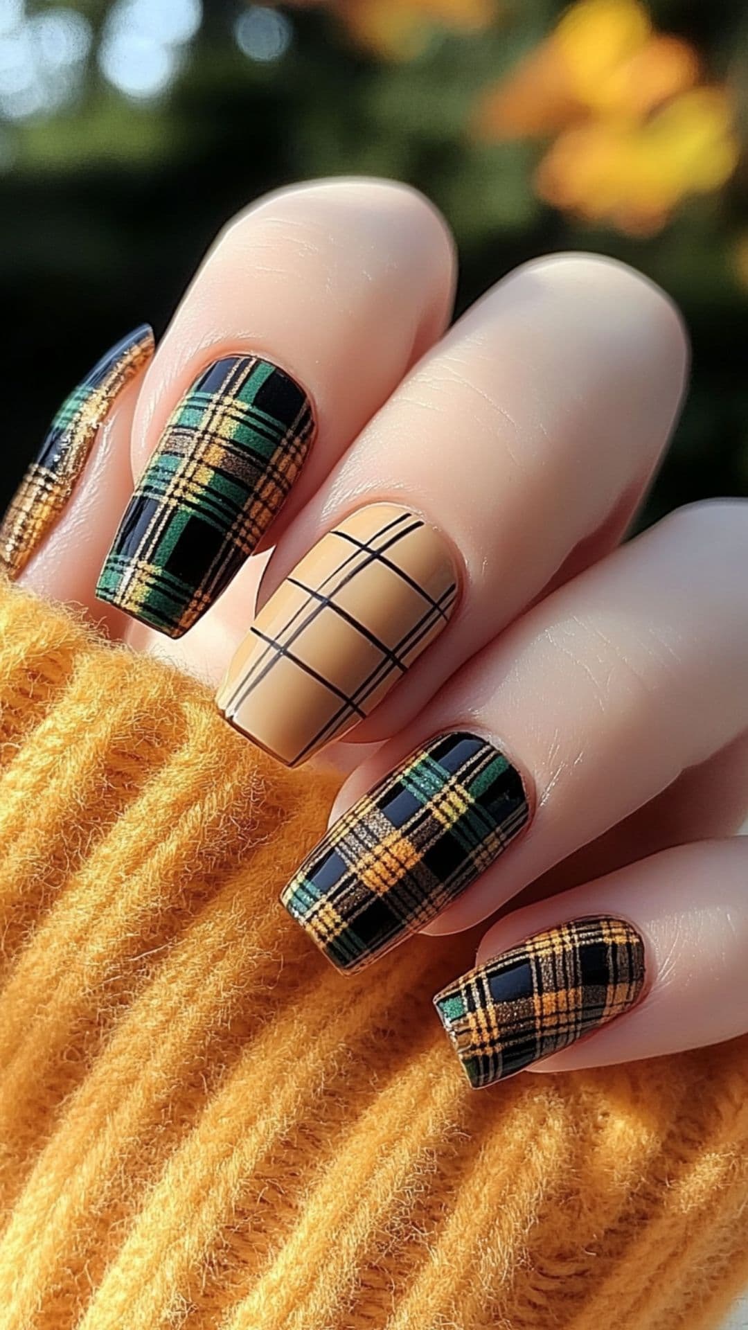 Woman's nails with Plaid Patterns in Warm Tones design.