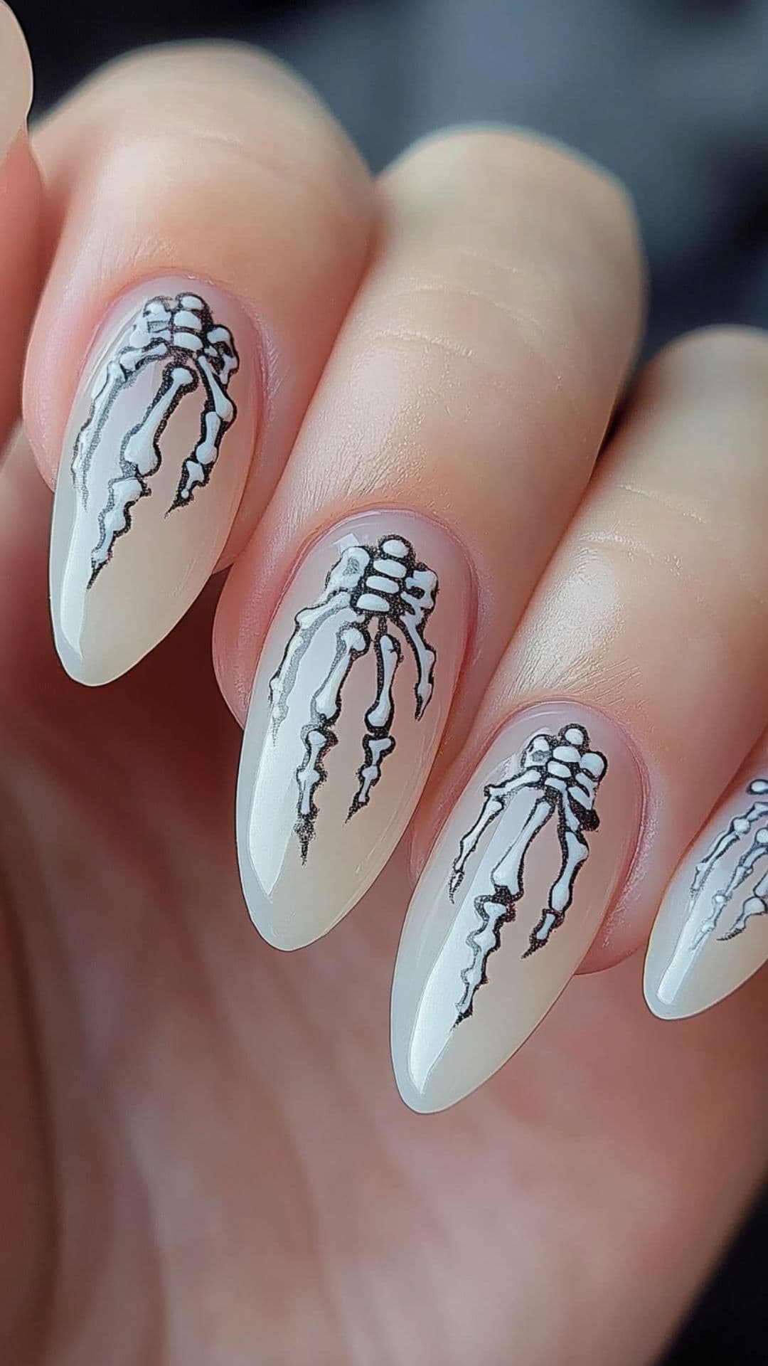 A woman's hand modelling Skeleton Fingers on almond nails.