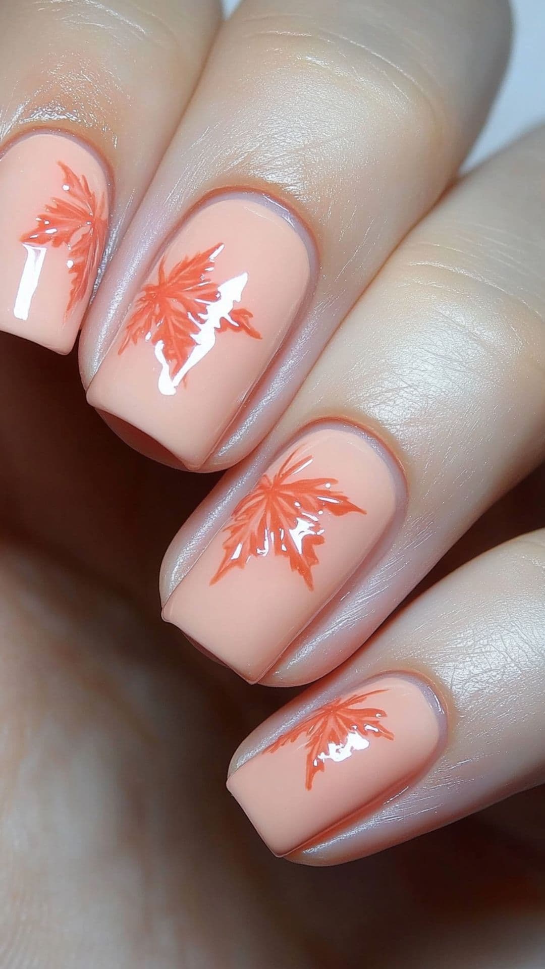 Woman's nails modelling Soft Peach Base with Maple Leaves design.