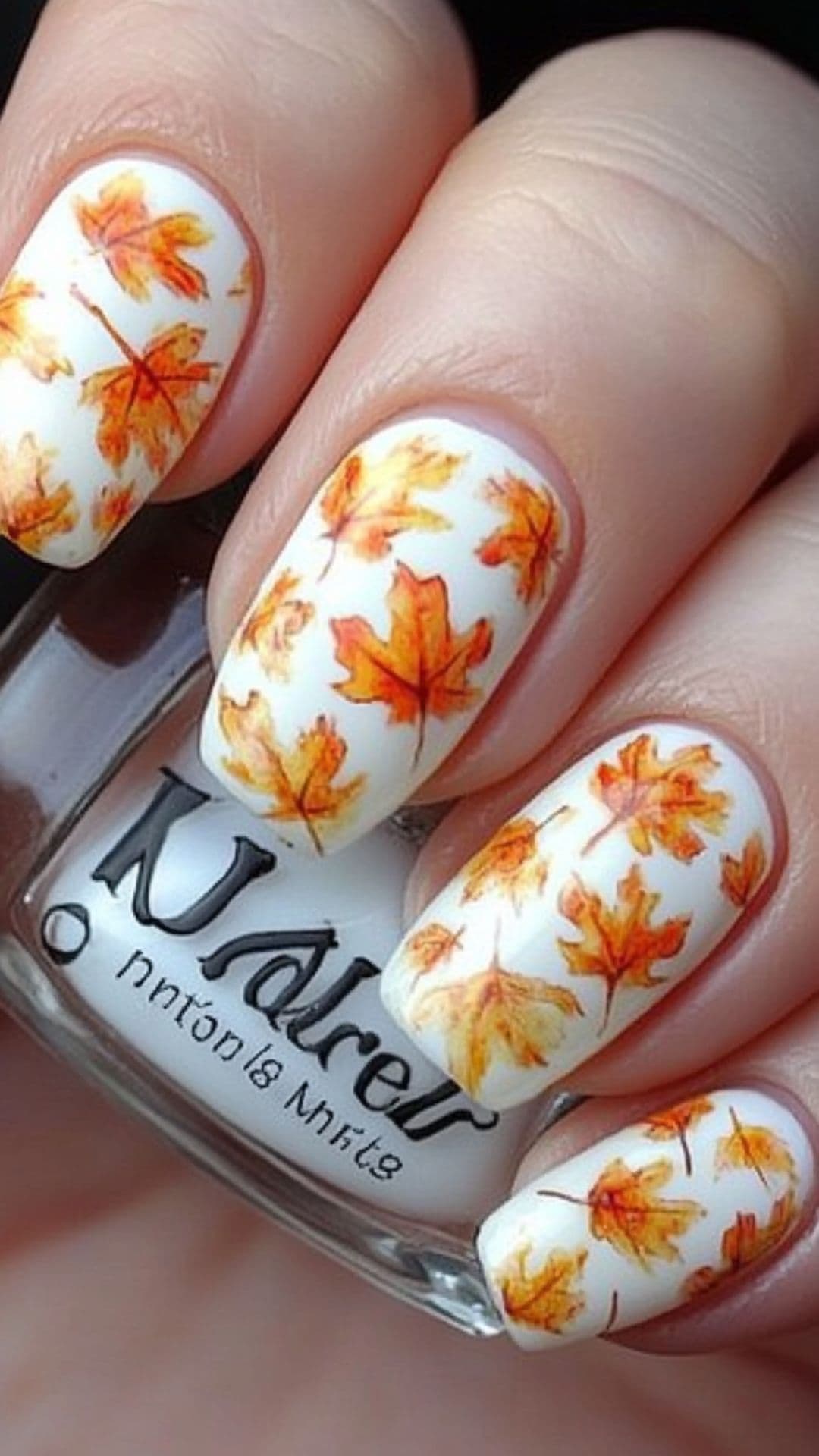 Woman's nails modelling Watercolor Leaves design.