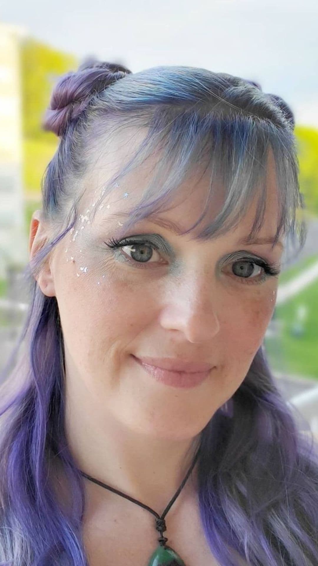 A woman modelling a Purple Twisted Buns hairstyle.